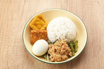 Nasi Gudangan, rice served with various vegetable with grated coconut seasoned and various side dishes. Indonesian food