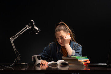 The girl is sitting at the table and study