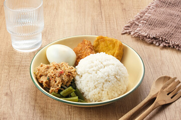 Nasi Gudangan, rice served with various vegetable with grated coconut seasoned and various side dishes. Indonesian food