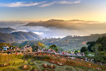 A group of young people watching the sunrise on top of a tea hill in Cau Dat, Da Lat town, Lam Dong...