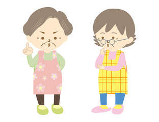 エプロンをつけたシニアの女性二人が会話をする様子