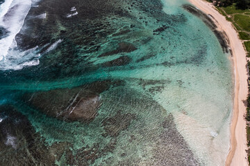 Aerial landscape tow view of beach and oceanic coastline with a reef who protects the Island and the beach