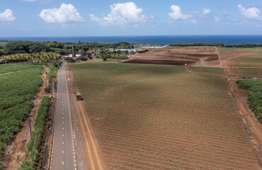 Mauritius aerial landscape view of sugar cane plantation and fields located countryside crossed by...
