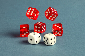 Random number generator. Red and white dice with numerical values lie in a chaotic order.