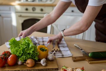 Cooking in the kitchen diet menu, healthy food, ready snacks delivery concept. Hands of the chef in the frame for cooking