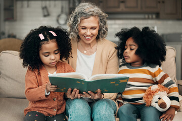Family kids, book and grandma reading fantasy storybook, story or bonding on home living room sofa. Grandmother love, novel and elderly woman with child development for biracial kindergarten children - Powered by Adobe