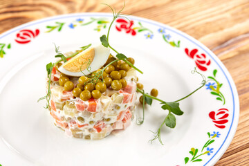 russian salad on the wooden background