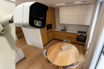 Modern CCTV camera installed in entryway of apartment building