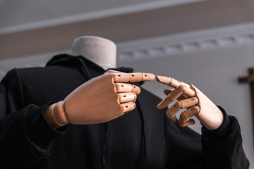 Wooden hand posting poiting sign isolated with headless body. Gesture fingers. Forefingers pointing.