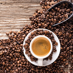 Top view of cup of Italian espresso with roasted coffee beans on rough wooden background. Empty...