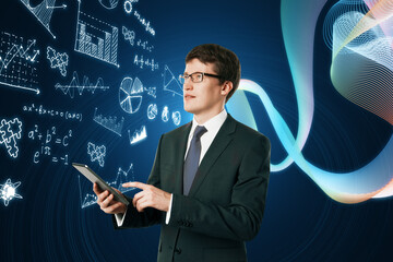 Portrait of attractive young european businessman using mobile phone with glowing mathematical formulas hologram on blurry blue background. Equation, digital data and mathematics app concept.