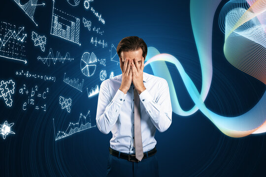 Portrait of stressed young european businessman covering face with glowing mathematical formulas hologram on blurry blue background. Equation, digital data and mathematics app concept.