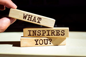 Wooden blocks with words 'What Inspires You?'.