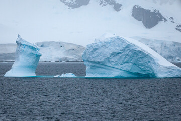 Stark, stunning and each unique, huge icebergs are sculpted by nature and weathered by changing climate as they float slowly through the antarctic oceans.