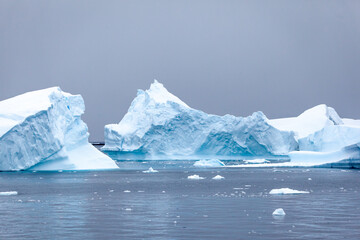 Stark, stunning and each unique, huge icebergs are sculpted by nature and weathered by changing climate as they float slowly through the antarctic oceans.