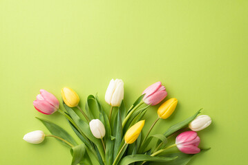 8-march concept. Top view photo of bouquet of pink yellow and white tulips on isolated light green...