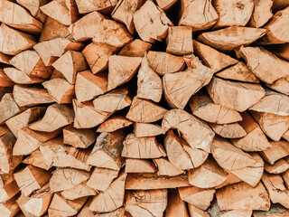 Lumber natural texture, organic wooden background. Stacked logs of firewood.