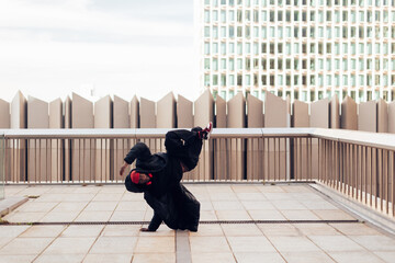 modern dancer of funky hip hop music performs a freestyle on an urban city space