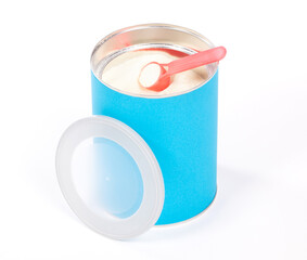 Baby milk powder in can that is open, with a spoon