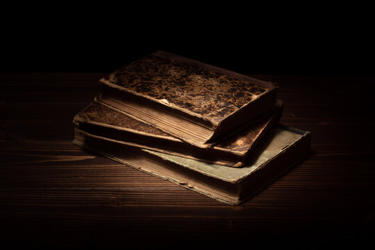 Antique books on a wooden table.