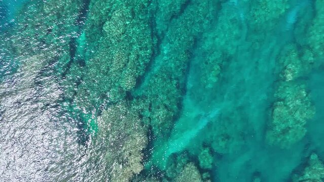 Take a picture of the beautiful emerald green sparkling sea with a drone