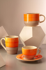 Colorful clay ceramic cups on gray background