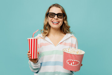 Young smiling cheerful fun woman in 3d glasses wear striped hoody watch movie film hold bucket of...