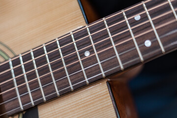 Fototapeta premium male hands playing acoustic guitar, close up.Acoustic guitar with a beautiful wood .
