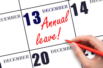 Hand writing the text ANNUAL LEAVE and drawing the sun on the calendar date December 13