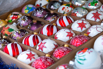 European Christmas market stall in  Old Town. colorful Christmas ornaments are some of the most popular souvenirs with tourists at seasonal fairs.