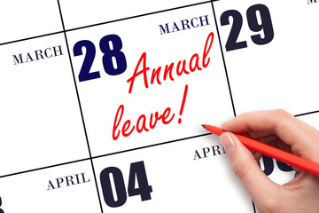 Hand writing the text ANNUAL LEAVE and drawing the sun on the calendar date March 28