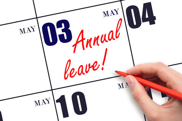 Hand writing the text ANNUAL LEAVE and drawing the sun on the calendar date May 3