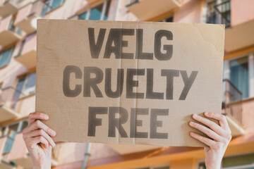 The phrase " Choose cruelty free " is on a banner in men's hands. Animal rights protest. Protection. City. Urban. Rally. Freedom. Stop animal testing. Equality. Justice. Care. Life. Humanity