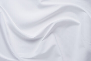 Fototapeta na wymiar White fabric. luxurious white fabric texture background. Creases of satin, silk and cotton.