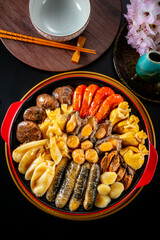 traditional giant hot pot Peng cai with dry seafood abalone sea cucumber crab prawn meat scallop oyster mushroom with thick brown sauce in red claypot asian Chinese new year luxury hotel menu