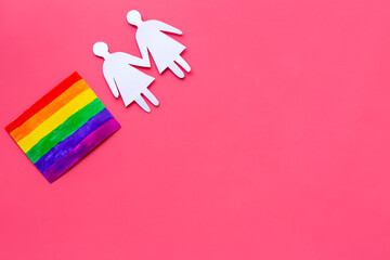 Gay pride rainbow LGBT flag with women couple paper shapes. LGBT social rights concept.