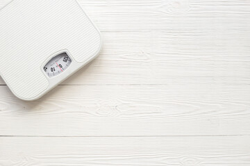White weight scales on the floor. Weight measurement and loss concept