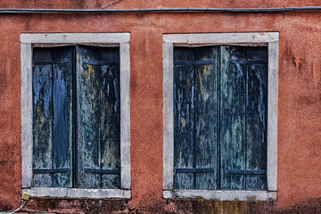 Fototapeta na wymiar blue window coverings on orange walls