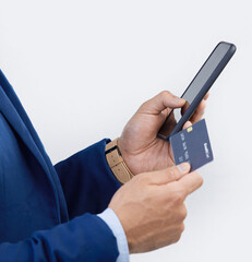 Credit card, phone and hands of man in studio for online shopping, fintech and investment. Banking, ecommerce and app with male isolated on gray background for customer experience, payment and retail