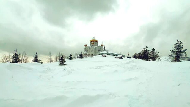 Belogorsky St. Nicholas Orthodox Missionary Monastery. Russia, Perm Krai, Belaya Gora. The temple on the hill in winter. Monastery on the background of snow. 4K
