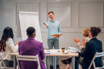Fototapeta premium Redhead businessman holding a presentation during a meeting in an office