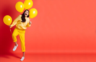 Laughing woman with yellow balloons on a red background with copy-space. World Laughter Day concept. April Fool's Day celebration. Generative AI