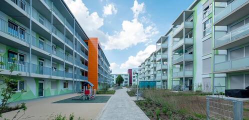two modern apartment block buildings, artistic designed with a pattern of polygonal shapes, symbolizing floral elements