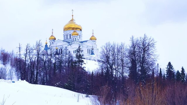 Belogorsky St. Nicholas Orthodox Missionary Monastery. Russia, Perm Krai, Belaya Gora. The temple on the hill in winter. Monastery on the background of snow. 4K
