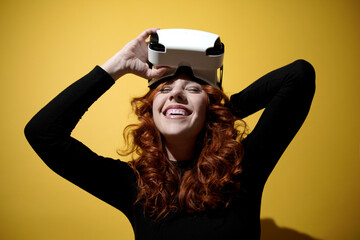 woman taking off her virtual reality glasses while smiling