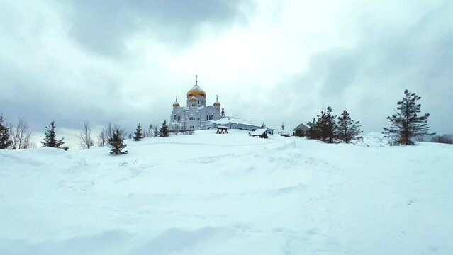 Belogorsky St. Nicholas Orthodox Missionary Monastery. Russia, Perm Krai, Belaya Gora. The temple on the hill in winter. Monastery on the background of snow. 4K