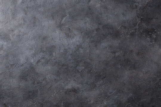 Black monochrome concrete wall or floor grunge textured background. Stone or slate backdrop.