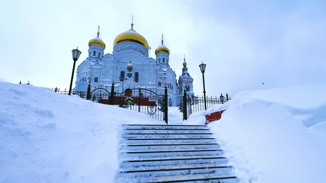 Belogorsky St. Nicholas Orthodox Missionary Monastery. Russia, Perm Krai, Belaya Gora. The temple on the hill in winter. Monastery on the background of snow. 4K