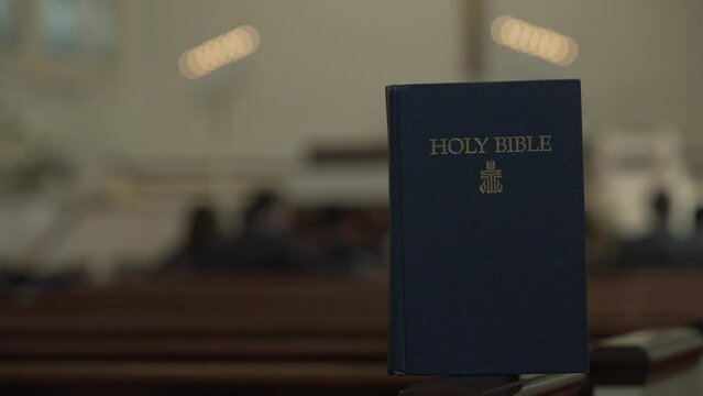 Holy Bible Resting in Church - Blurred Background
