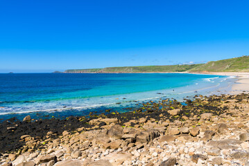 Sennen Cove beach and Cape Cornwall, beautiful bay with crystal clear turquoise water. Popular spot for surfing. England, UK.